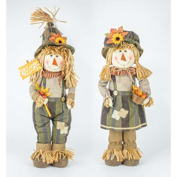 Two scarecrow figurines with sunflower hats and a welcome sign