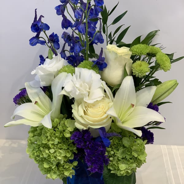 Blue and white floral arrangement in a cobalt vase