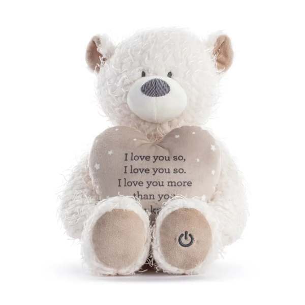 White teddy bear holding a heart with printed text