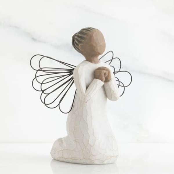 Kneeling angel figurine with wire wings and hands clasped at the chest