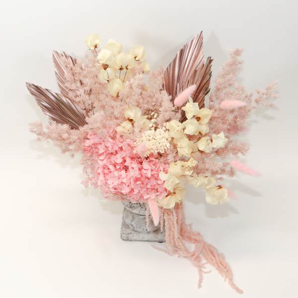 Pink and cream dried floral arrangement in a gray vase
