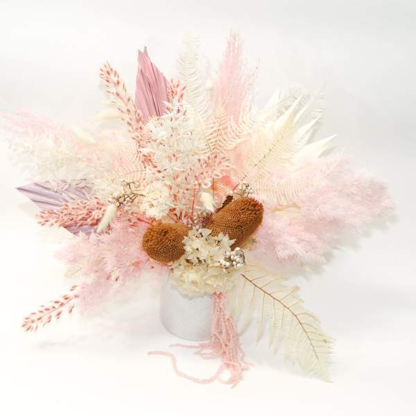 Pastel dried floral arrangement in a white vase