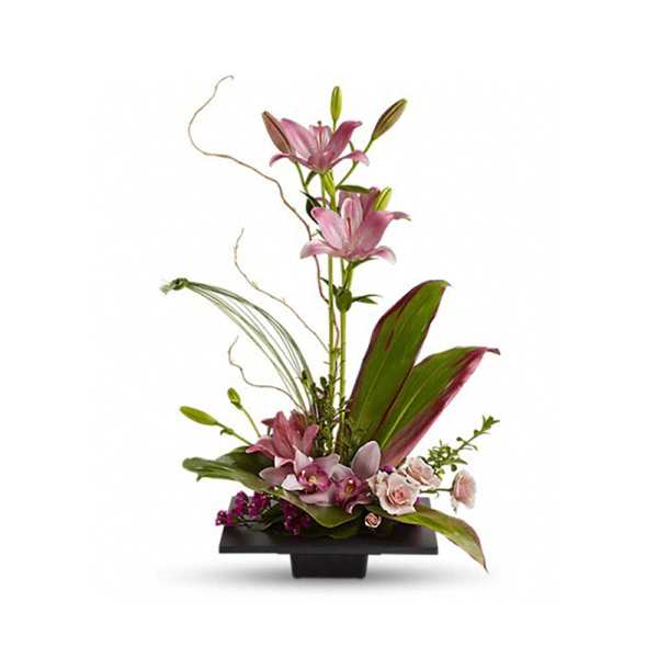 Modern pink lily and orchid arrangement in a low black rectangular container
