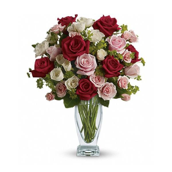 Bouquet of red, pink, and white roses in a clear glass vase