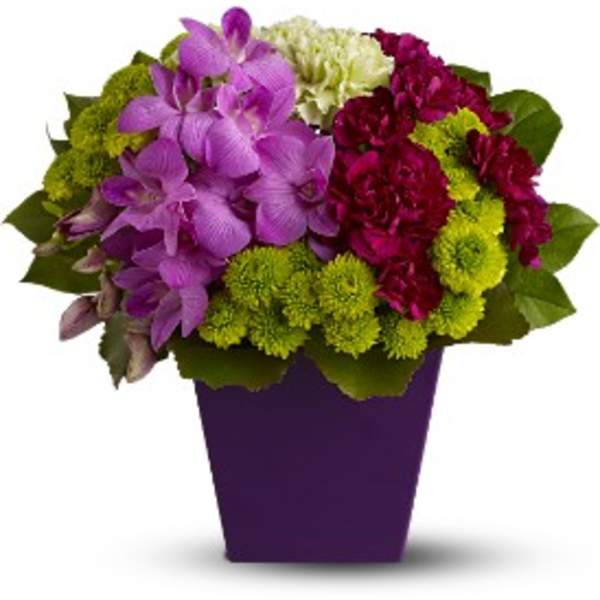 Purple and magenta flowers arranged in a purple vase