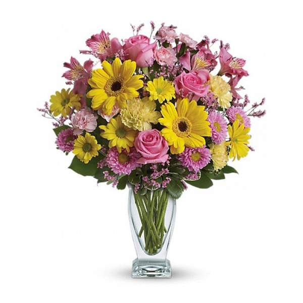 Bouquet of pink roses and yellow daisies in a clear glass vase