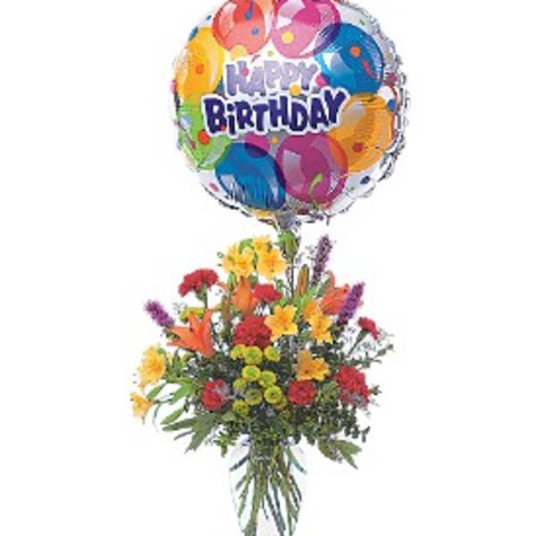 Birthday balloon above a colorful mixed flower arrangement in a vase