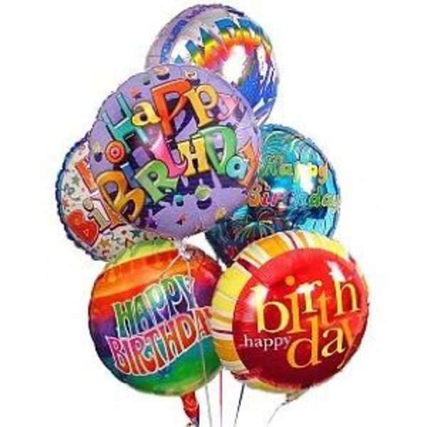 Cluster of colorful birthday balloons with printed messages