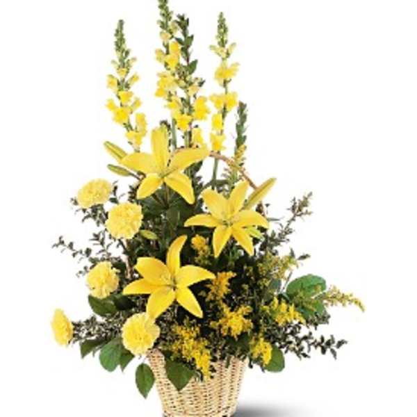 Tall yellow lily and carnation basket arrangement with mixed filler flowers