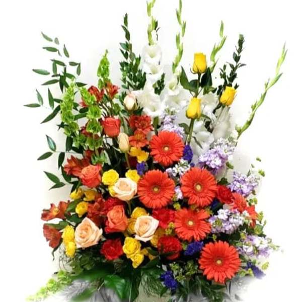 Tall mixed bouquet with red gerberas, roses, and white lilies