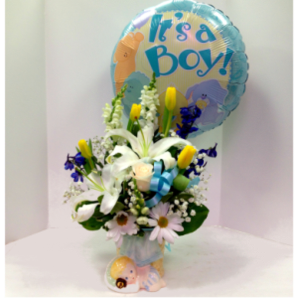 Bouquet with white lilies and daisies, topped by a blue "It's a Boy!" balloon