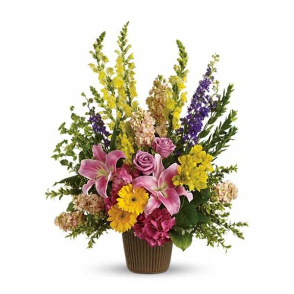Tall mixed bouquet in a brown vase with pink lilies and yellow flowers