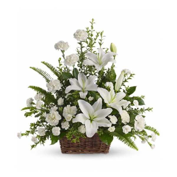 White lilies and carnations in a fan-shaped basket with abundant greenery