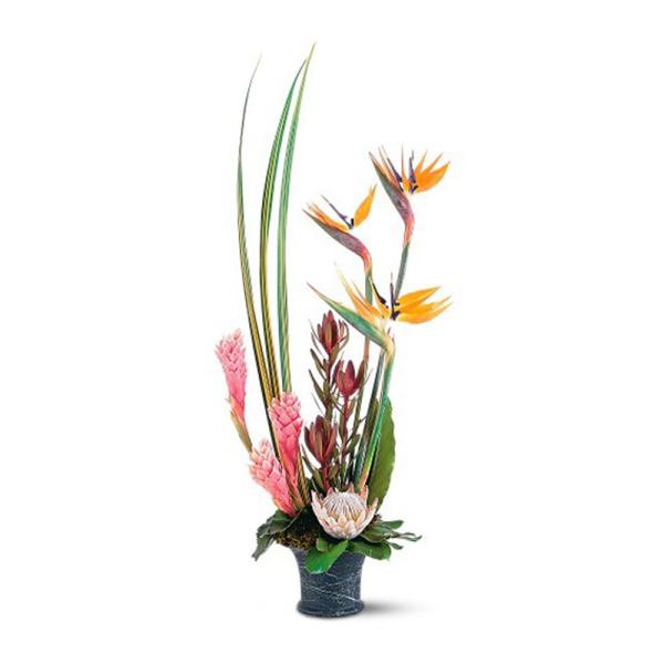 Tall tropical arrangement with birds of paradise and pink blooms in a dark vase