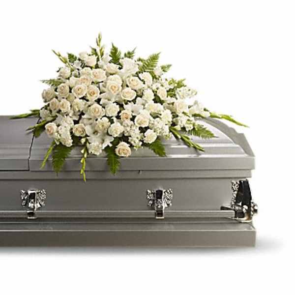 White floral spray on a gray casket
