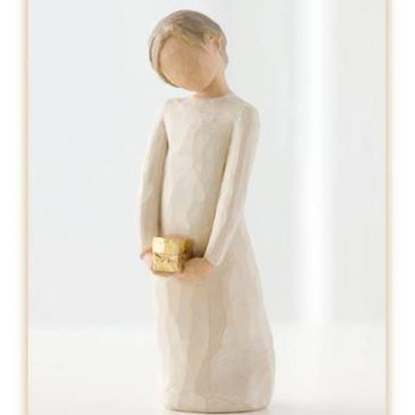 Wooden figurine of a girl holding a small gold gift box