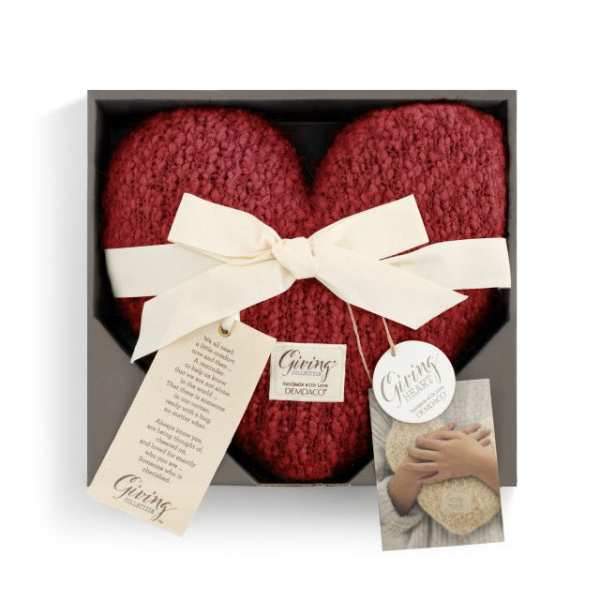 Red knitted heart gift in a box with a white ribbon and tags