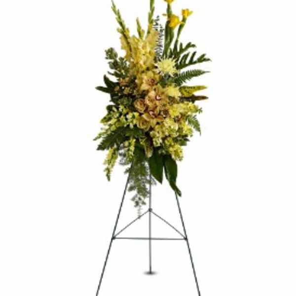 Tall yellow floral standing spray on a metal easel