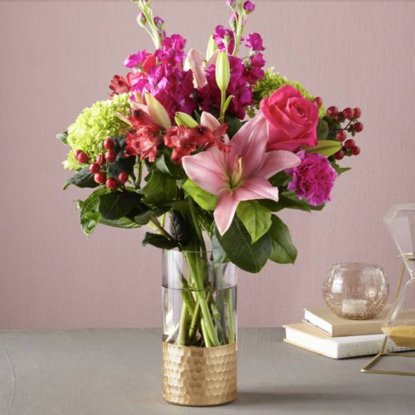 Pink and magenta floral arrangement in a clear glass vase