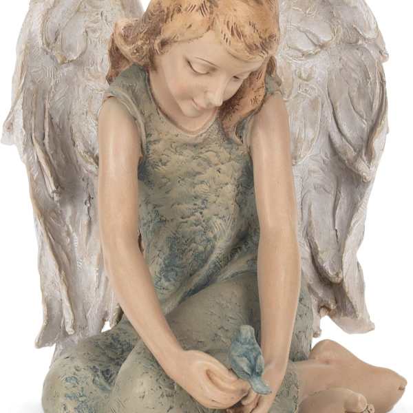 Seated angel figurine holding a small bird