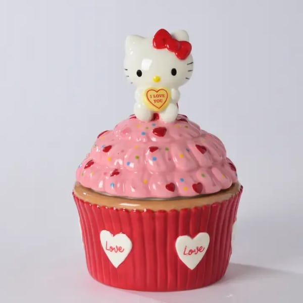 Hello Kitty figurine on a pink cupcake-shaped gift container