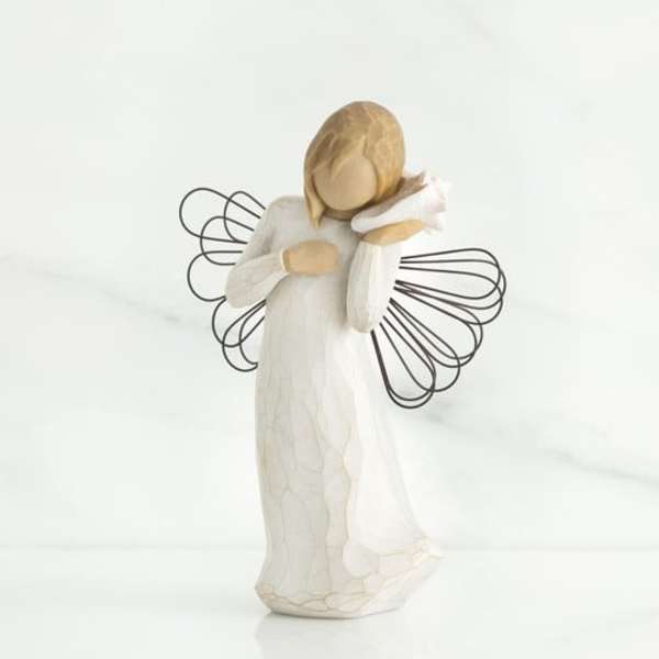Small angel figurine in a white dress with wire wings