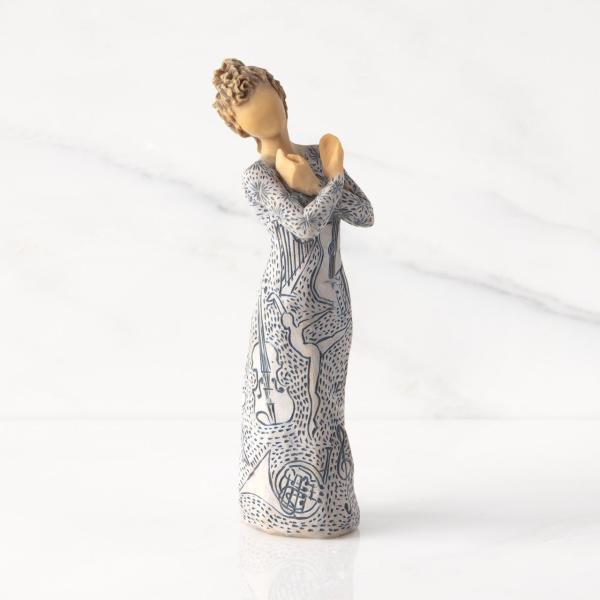 Decorative figurine of a woman in a patterned dress