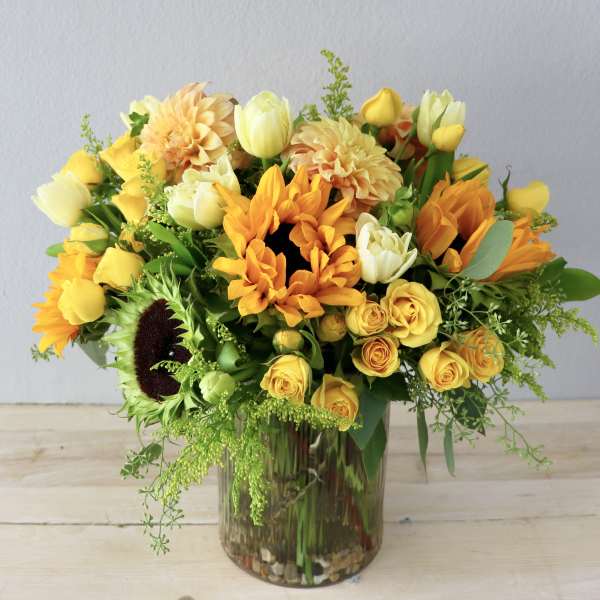 Yellow and orange mixed bouquet in a glass vase