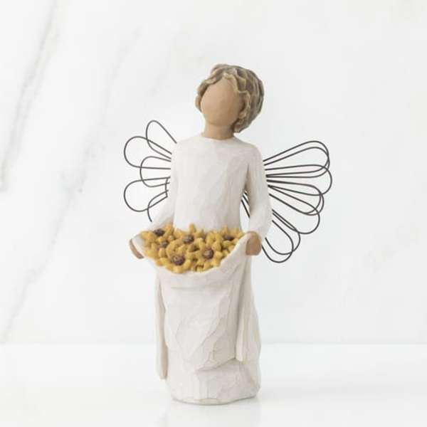White angel figurine holding a basket of yellow flowers