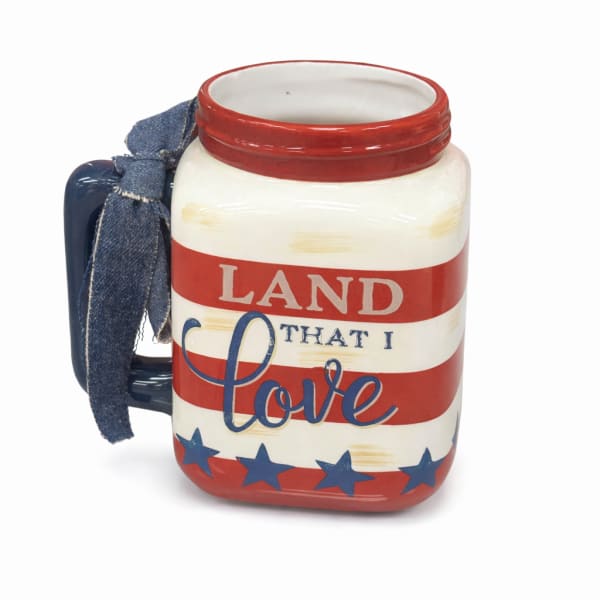 Patriotic ceramic mug with a denim handle and "Land that I love" text