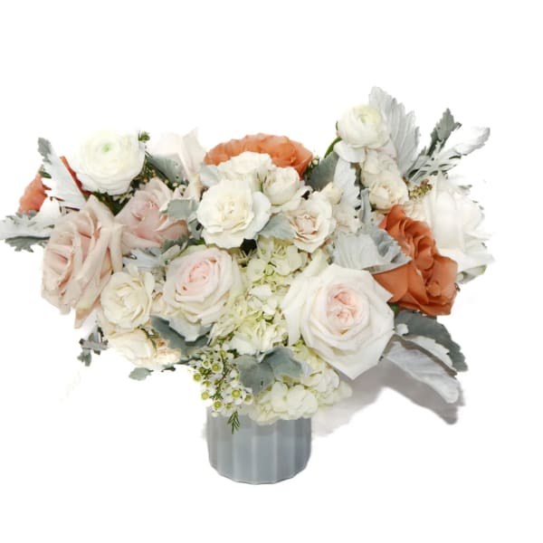 White and blush rose bouquet in a gray vase
