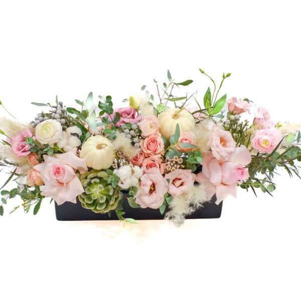 Low floral centerpiece with pink and white blooms in a black rectangular container