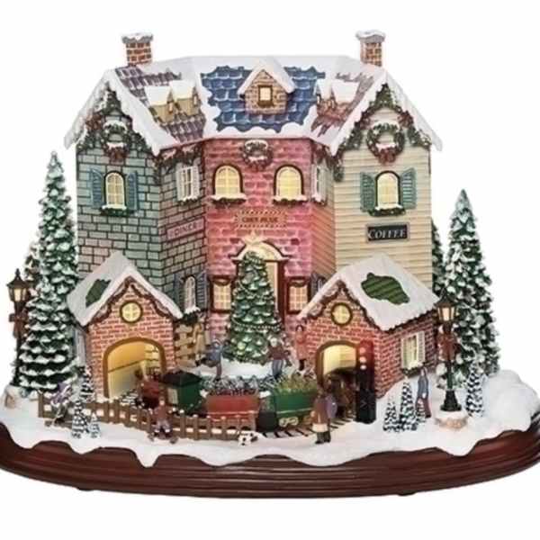 Miniature snowy village house display on a wooden base
