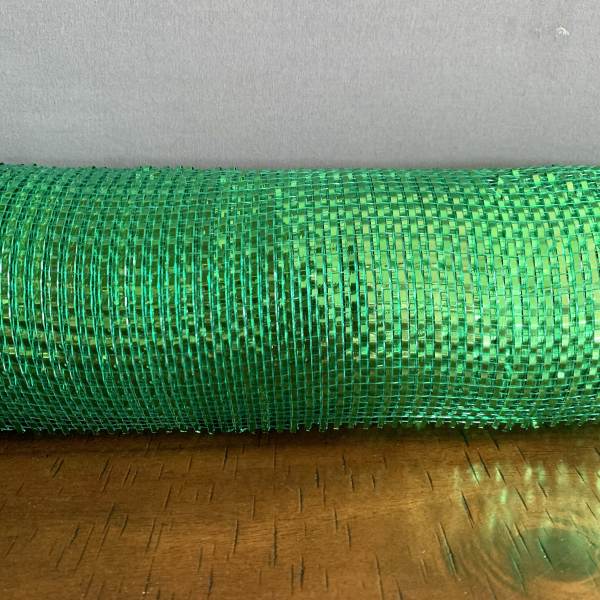 Roll of bright green mesh ribbon on a wooden surface