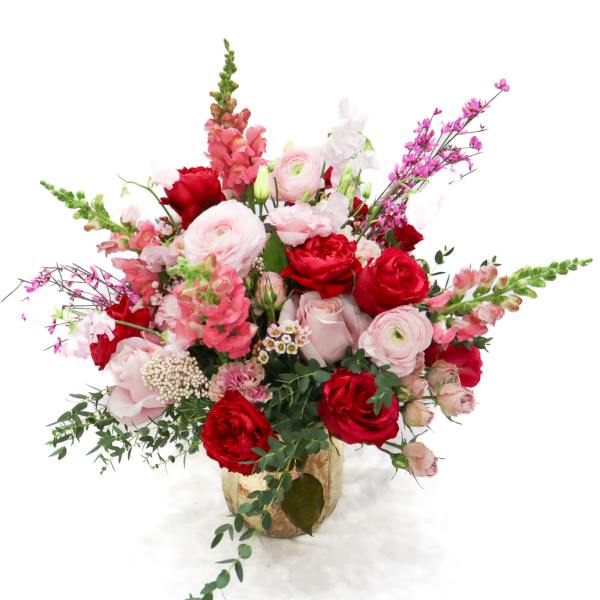 Pink and red mixed flower arrangement in a vase