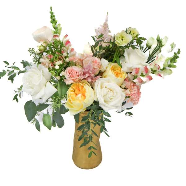 Mixed bouquet of white, pink, and yellow flowers in a gold vase