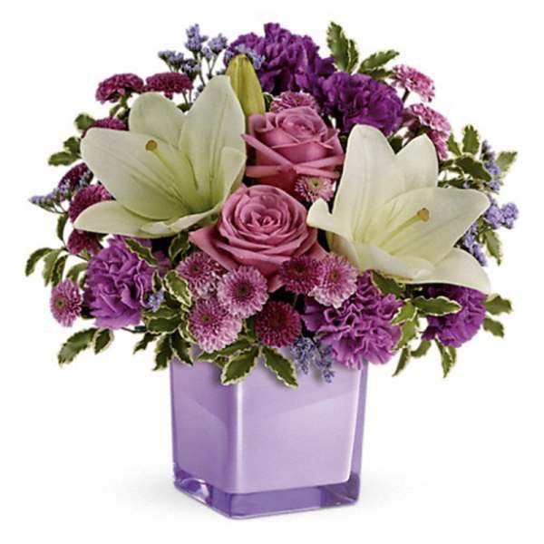 Purple and pink bouquet with white lilies in a lavender vase
