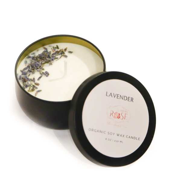 Two black tins of lavender soy wax candles, one open with dried petals on top