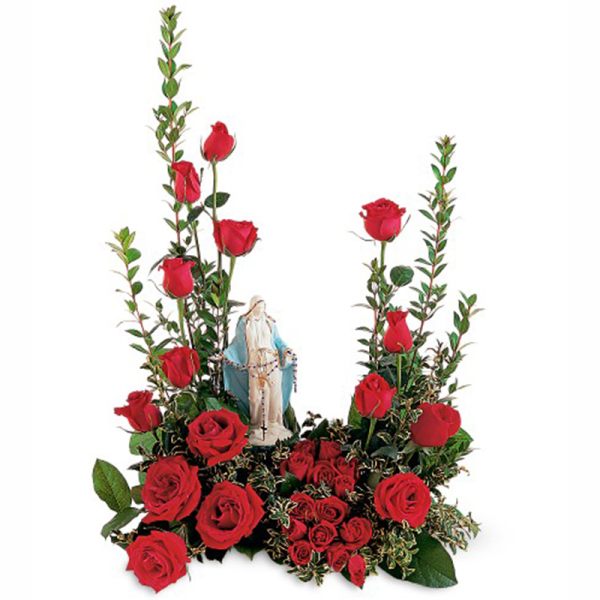 Red roses arranged around a small Virgin Mary figurine
