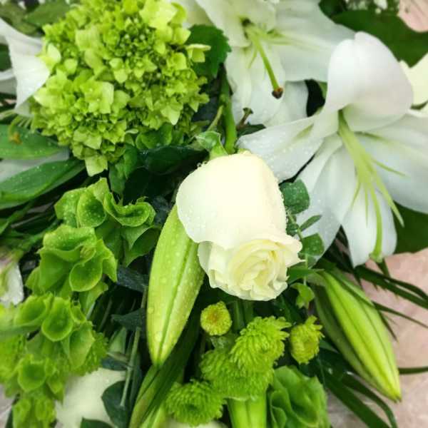 White lilies and green flowers in a bouquet