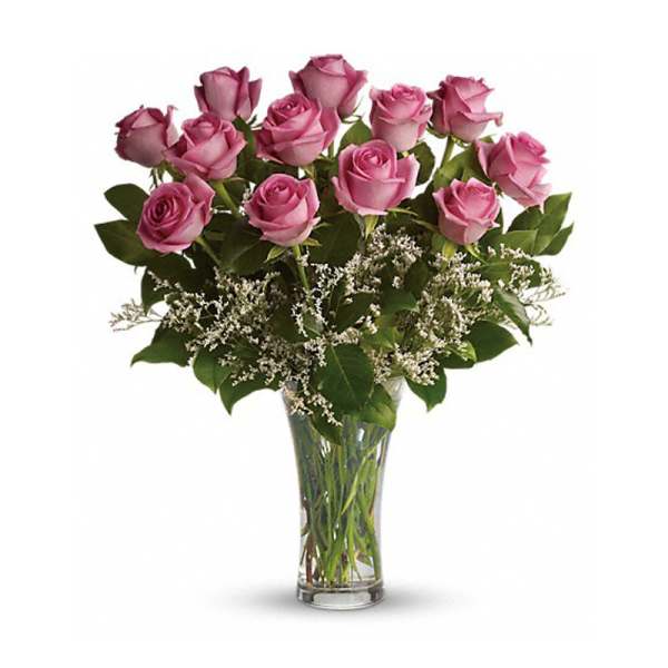 Pink roses arranged in a clear glass vase