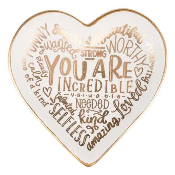 Heart-shaped decorative sign with gold lettering on a white background