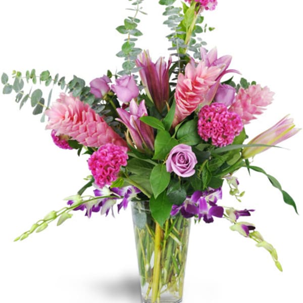 Pink and purple mixed bouquet in a clear glass vase