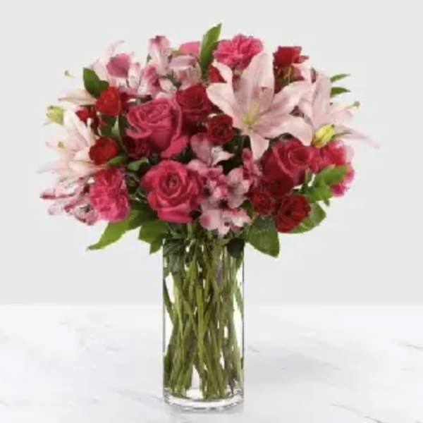 Pink and red bouquet in a clear glass vase