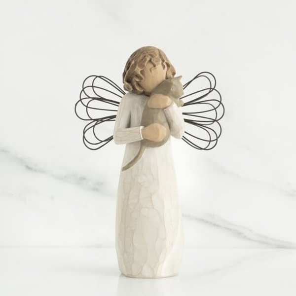 Small angel figurine holding a cat