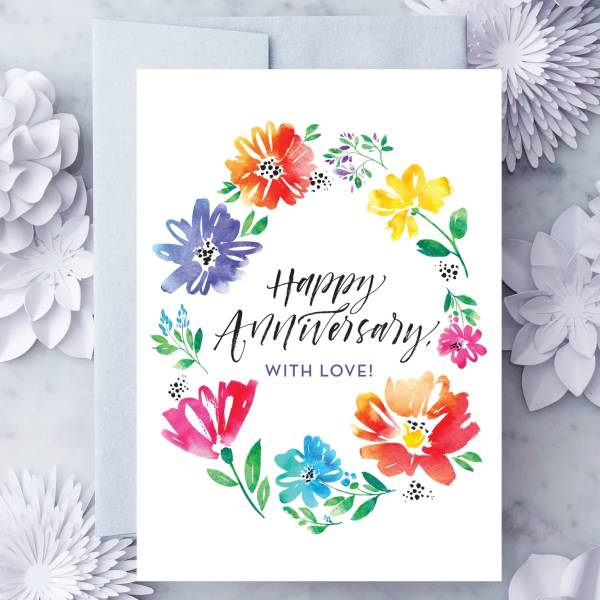 Anniversary card with colorful watercolor flowers around the text