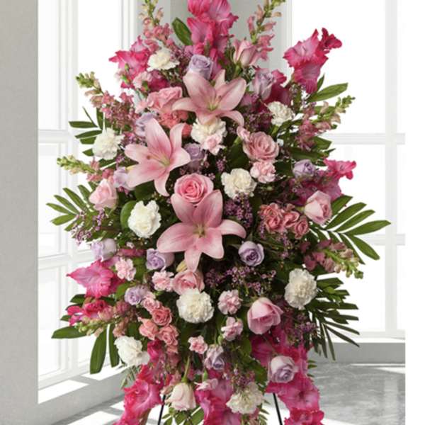 Tall pink and lavender floral standing spray on an easel
