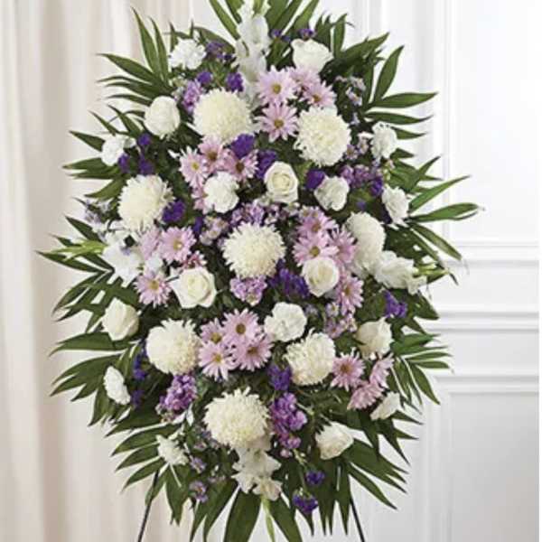 Standing floral spray with white, pink, and purple flowers on an easel