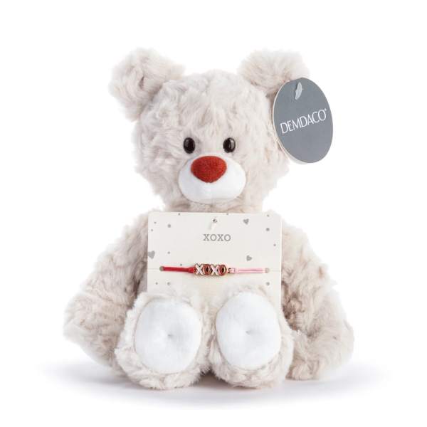 Plush teddy bear holding a XOXO bracelet card