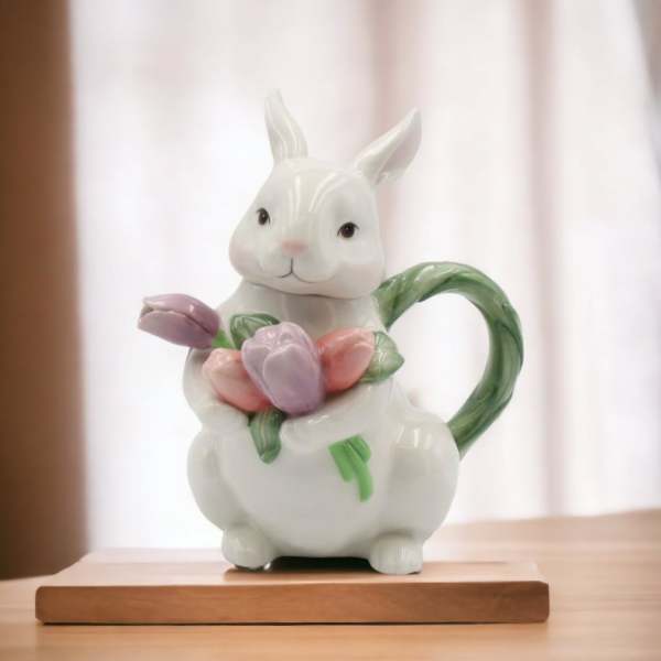 Ceramic rabbit figurine holding pastel tulips